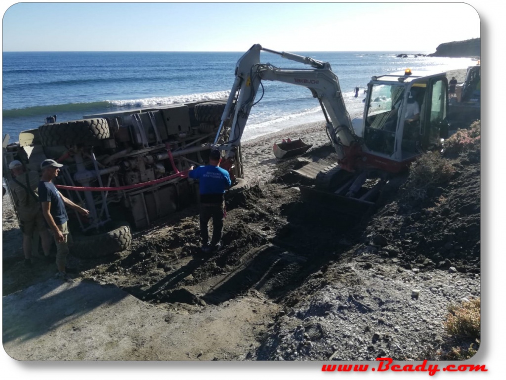 Unimog overlander camper fallen over, on it's side,  digger used to recover it