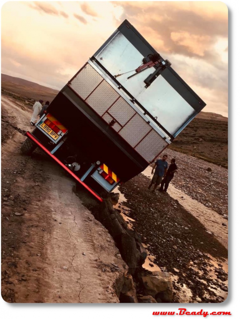 broken road big problem for overland truck, dangerous lean