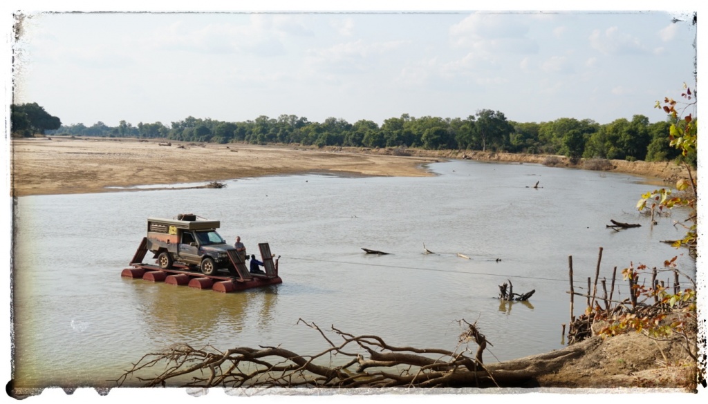 crossing crocodile infested river in a range rover