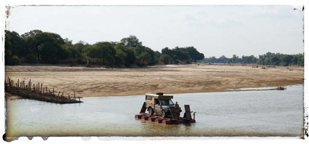 range rover on pontoon in Africa river crossing