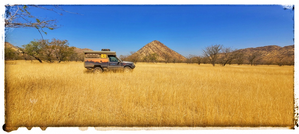 yellow grass for thousands of acres and just a range rover stood in it