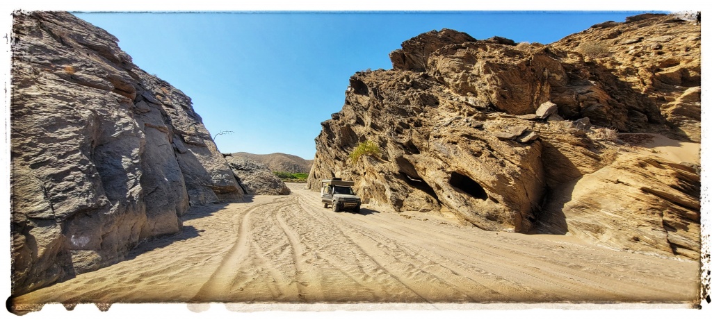 bit toight madame,range rover slips though narrow gap in the dry river bed 4x4 track desert