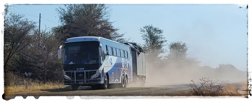 busses rcing along pot holed roads in zambia with trailers