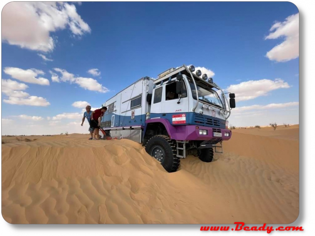 Kamaz overland truck stuck in the dunes top of dune