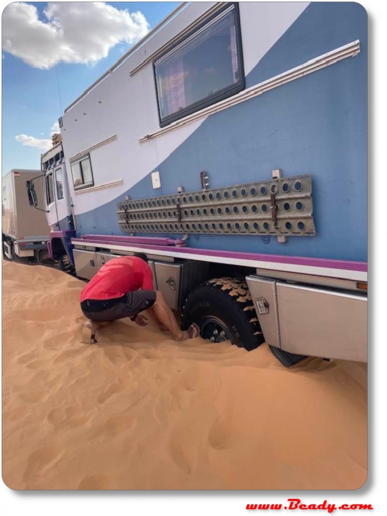 Kamaz overland truck stuck in the dunes wheels buried