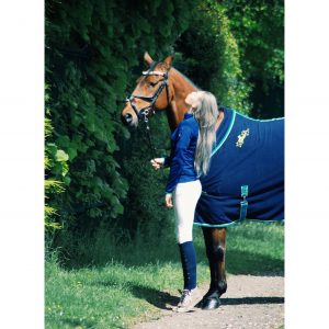 Chloe wearing the Maven fleece in navy and White knee-grip breeches. Crystal is wearing the Maven fleece show rug, we're a lover for navy!
