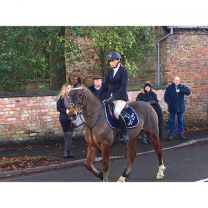 Chloe and Harold in the boxing day hunt in Woore wearing here Equestrian World of Maynooth saddle cloth.