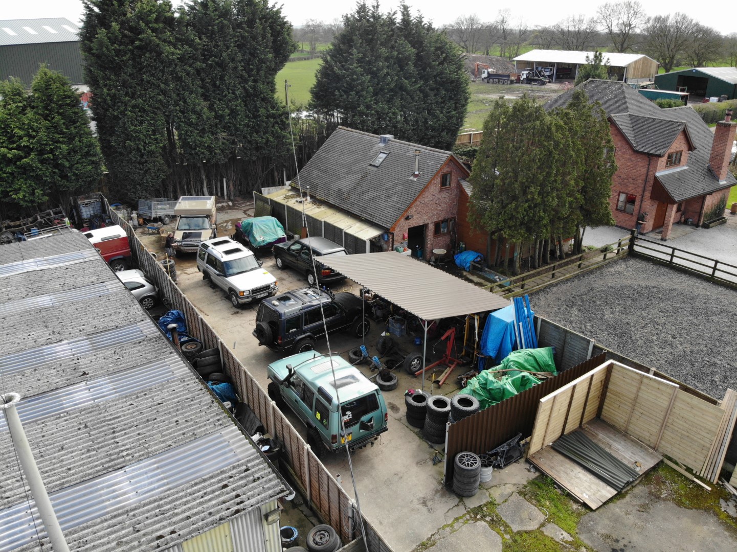 A gaggle of Land Rovers in a yard