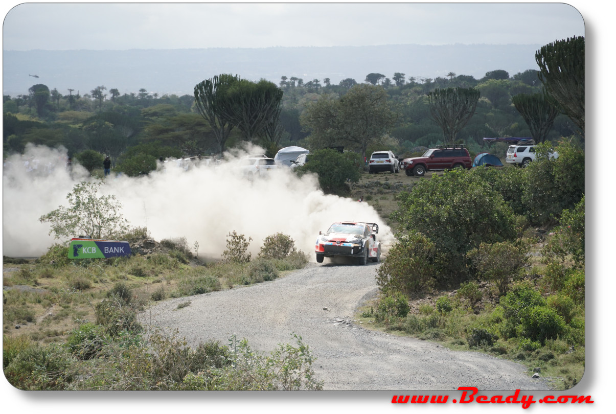 safari rallye car in tight corner looks like it's on fire
