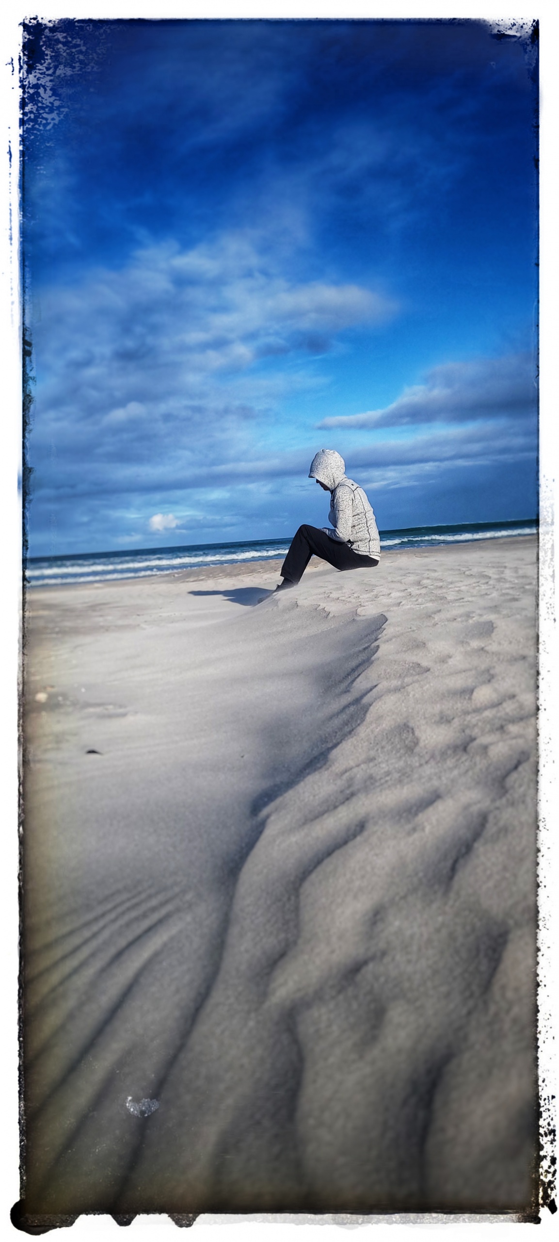 girl on white beach depressed