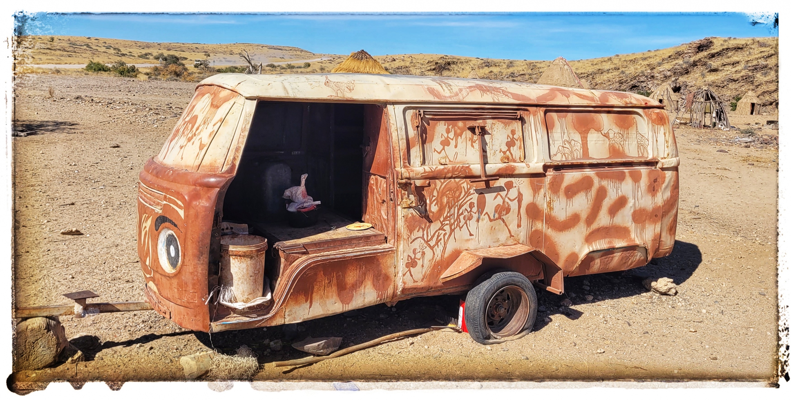 rusty VW campervan made into trailer in the desert