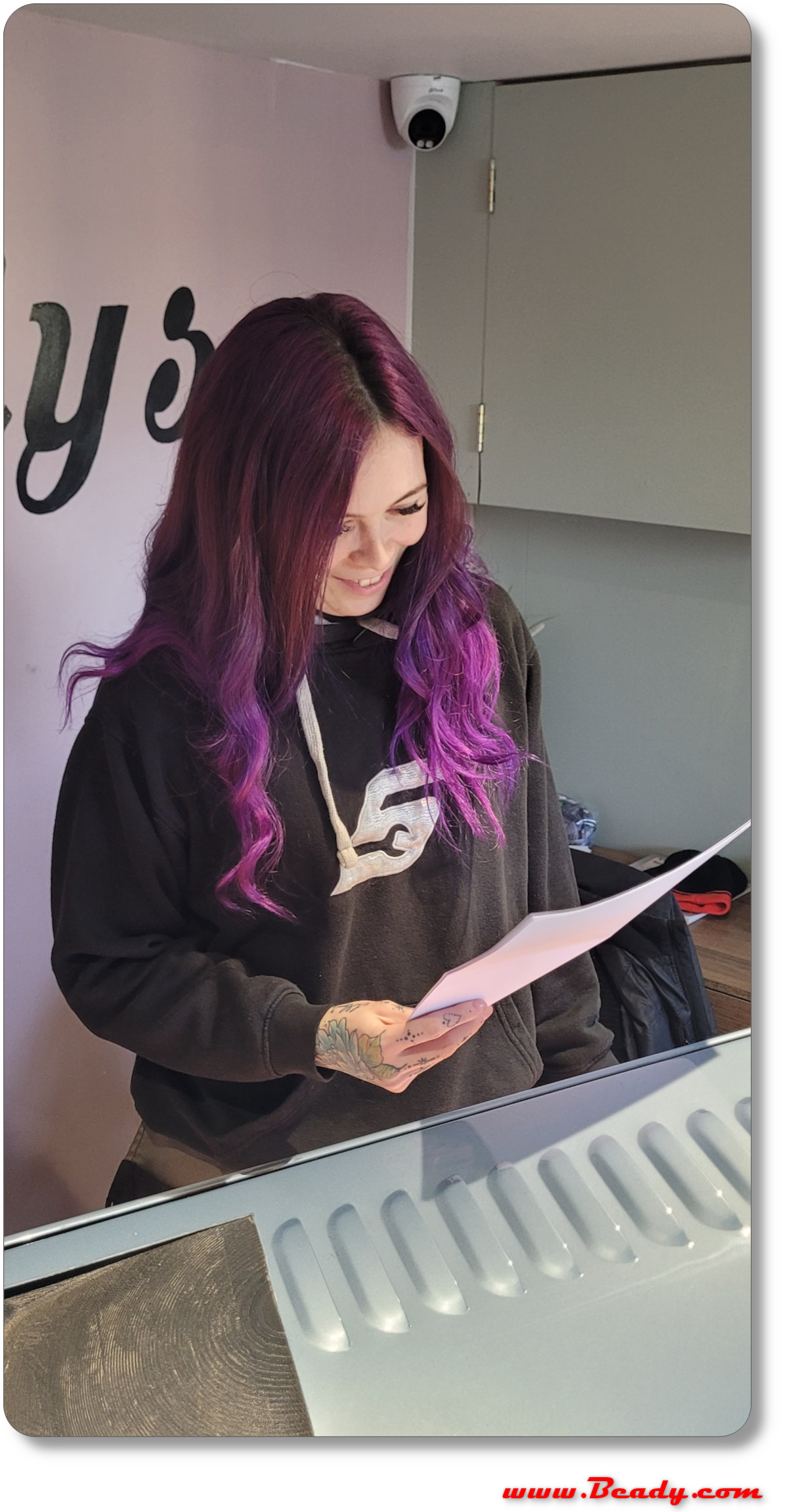 pretty girl reading paperwork with car