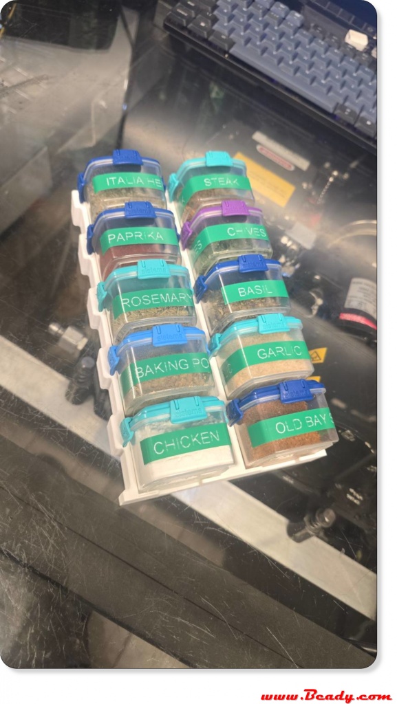 Custom overland spice rack holding 10 small Sistema 62ml containers mounted inside a shallow Eurobox drawer for off-road camping and expedition vehicle kitchens